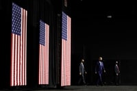 Image: Presumptive Democratic presidential nominee Joe Biden, center, arrives at a campaign event in Wilmington, Del., on July 14.