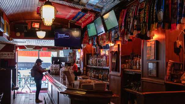 Rival Premier League fans have long shared this soccer bar. Now it is in trouble.