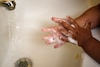 A child washes her hands in August at a Connecticut day-care center.