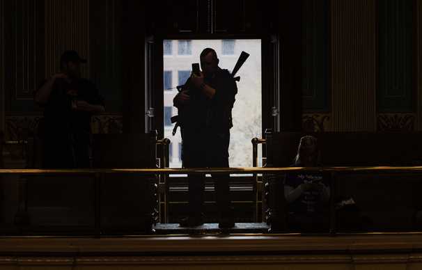 You can carry a gun into the Michigan Capitol. Democrats say it’s a workplace hazard.