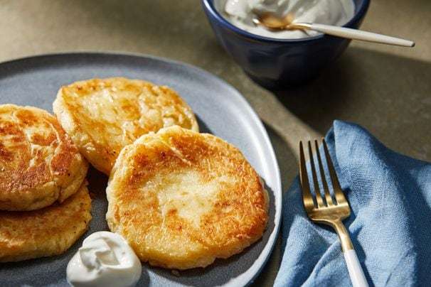 Tangy Russian syrniki, or farmer cheese pancakes, can be enjoyed sweet or savory