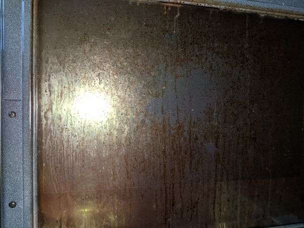 How can I get the brown crud off my oven’s glass door?