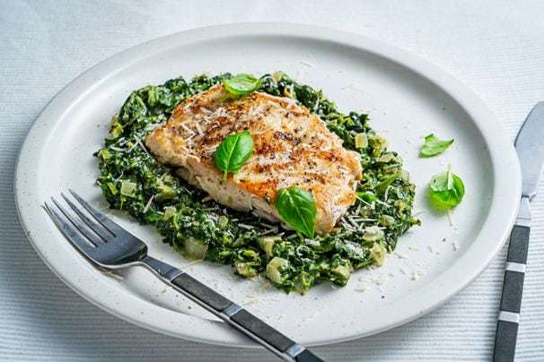 Creamed spinach gets promoted from side to star in this one-pan chicken skillet