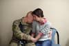 FORT CAMPBELL, KY., 2014 | Army Spec. Caleb McKinnon embraces his wife, Savannah McKinnon, as he and others prepare for deployment. 