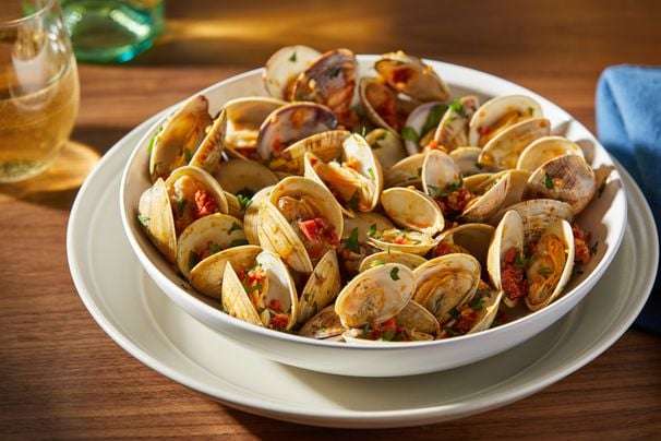 Grilled clams with a chorizo white wine sauce is a flavorful and breezy starter
