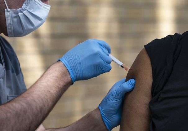 Federal workers can be fired for refusing vaccination, but must show up to work until their cases are determined, new guidance says
