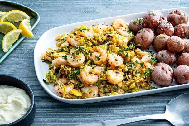 Pair shrimp with shredded Brussels sprouts and a garlicky aioli for a quick and festive supper