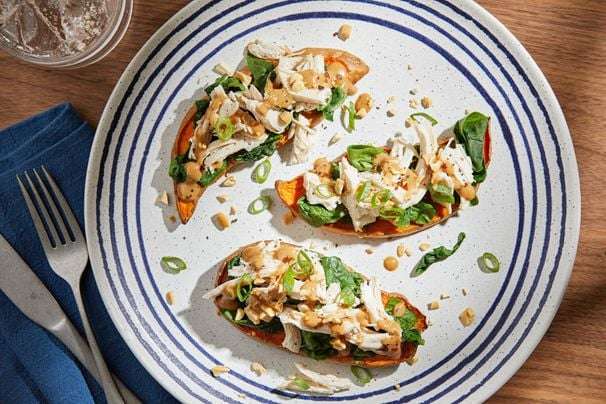 Stack sweet potato planks with chicken, spinach and peanut sauce for a hearty dinner