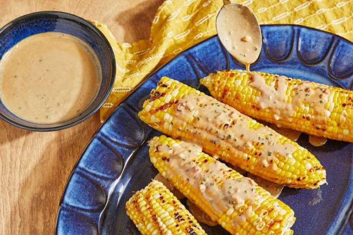 Grilled corn smothered with peanut sauce is a brilliant, tasty mess