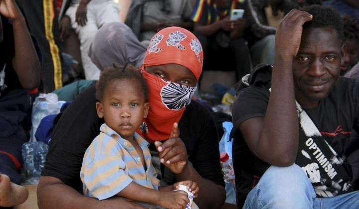 Under pressure, Tunisia takes back hundreds of migrants trapped in a border zone with Libya